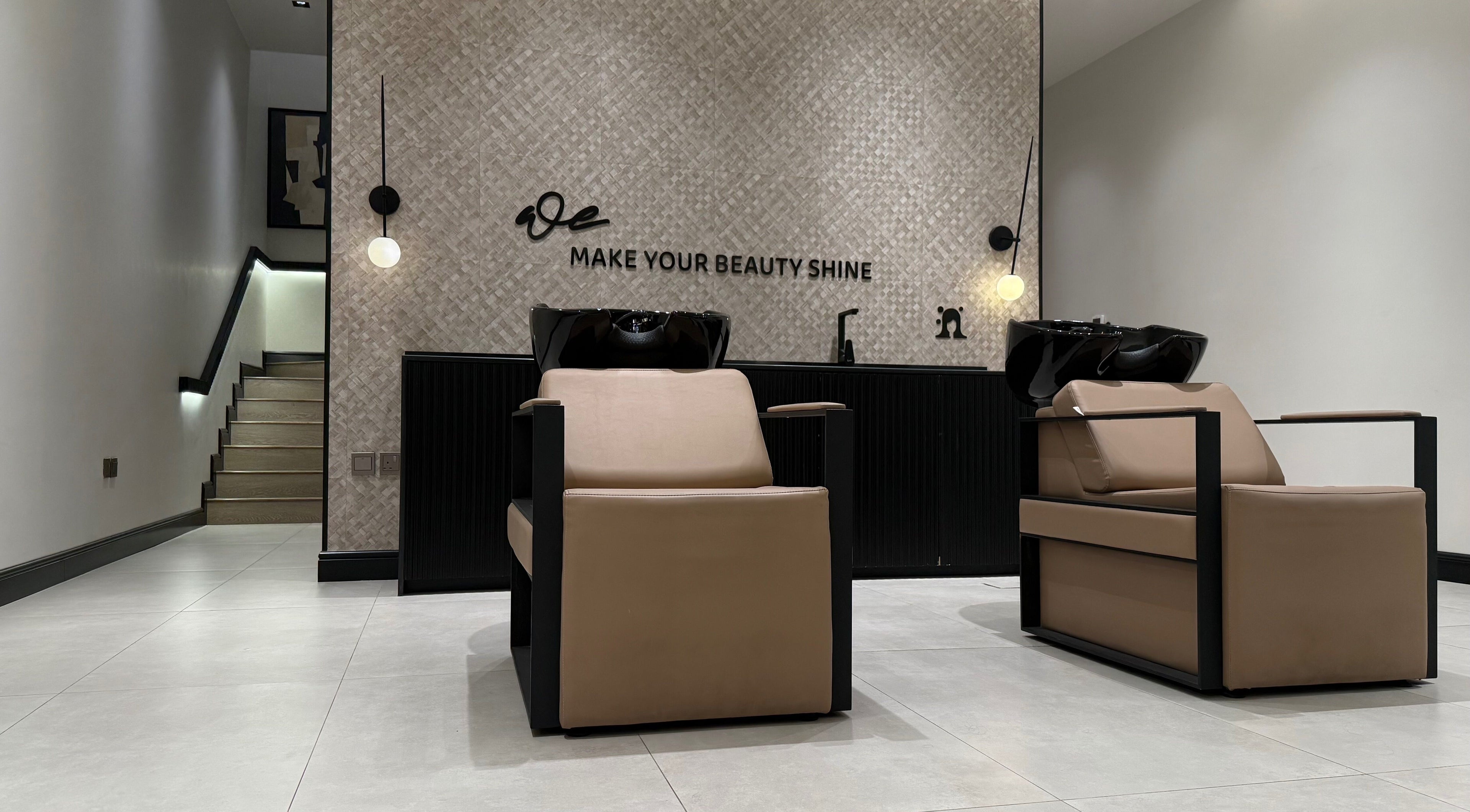 Modern salon interior at We Salon, Riyadh, Riyadh Province, SA showcasing chic hair-washing stations.