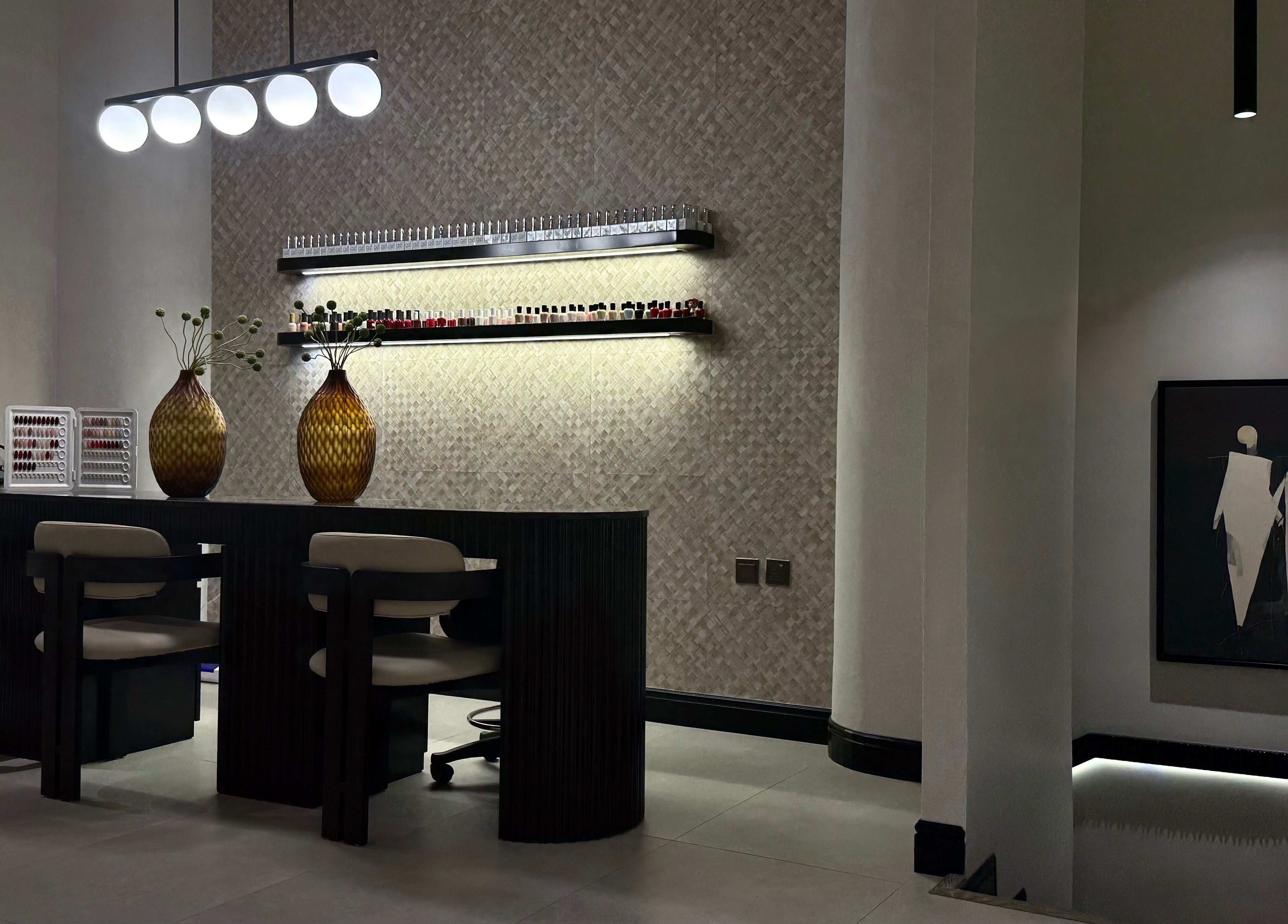 Modern nail lounge at We Salon, Riyadh, Riyadh Province, SA with elegant decor and lighting.