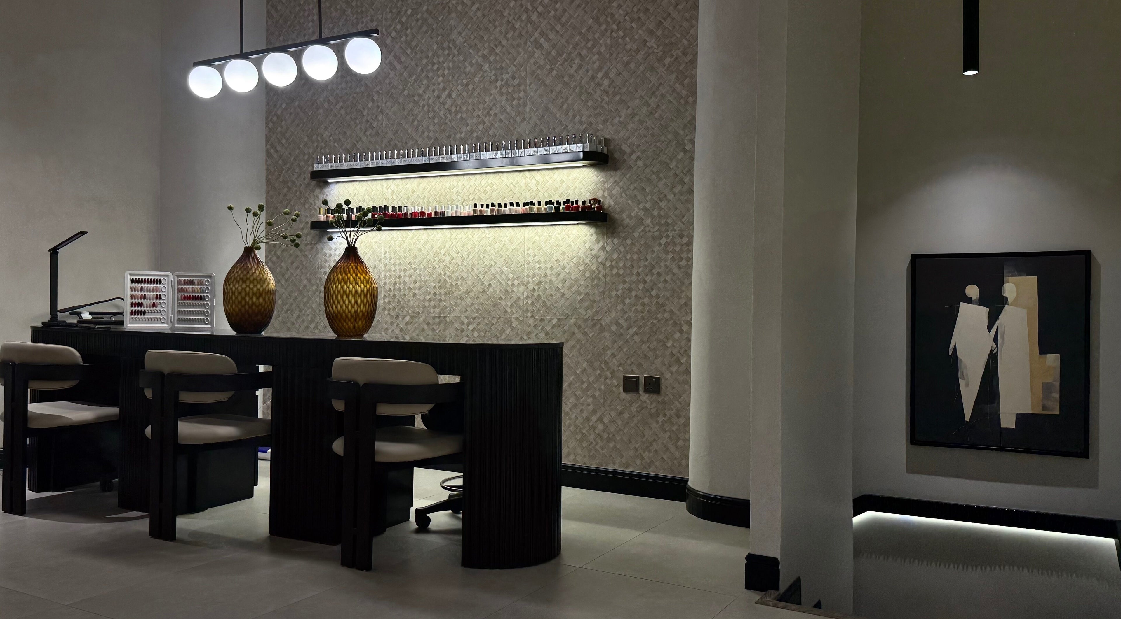 Modern nail lounge at We Salon, Riyadh, Riyadh Province, SA with elegant decor and lighting.