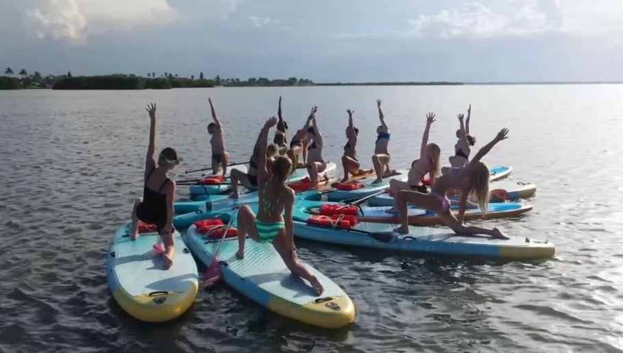 Group yoga on paddleboards at SoulVival Wellness, Merritt Island, Florida, US.
