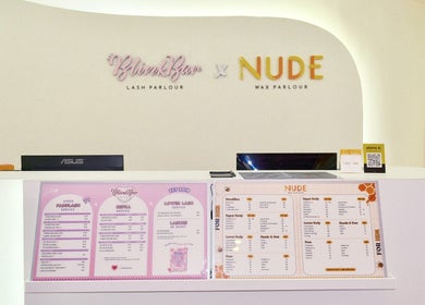 Reception desk at Blinkbar at Orchard Gateway, Singapore, SG showcasing service menus and modern decor.