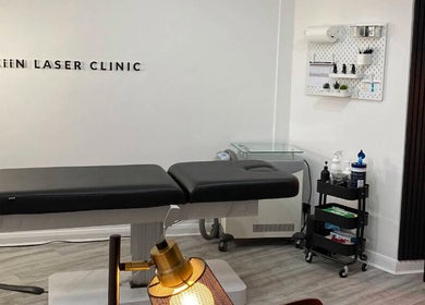 Modern treatment room at Skiin Laser Clinic in Peterborough, England, GB featuring a comfortable black treatment bed.