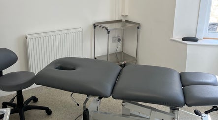 Professional treatment room at Align Enhancements, Barry, Wales, GB featuring adjustable massage table.