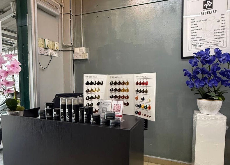 Qnd Barbershop in Hulu Langat, Selangor, MY features a stylish reception with products and flower decor.