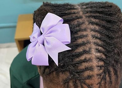 Elegant braided hairstyle with a lilac bow at Nubian Crown Durban, Durban, Kwazulu-natal, ZA.