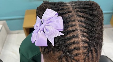 Elegant braided hairstyle with a lilac bow at Nubian Crown Durban, Durban, Kwazulu-natal, ZA.