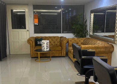 Chic waiting area in Lyns Beauty Salon, Shah Alam, Selangor, MY with plush couches and mirrors.