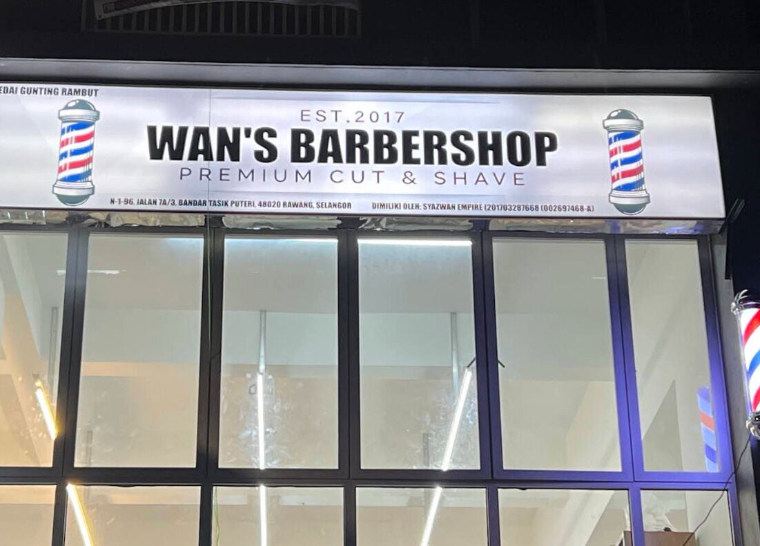 Illuminated sign of Wan’s Barbershop Tasik Puteri in Rawang, Selangor, MY showcasing premium styling services.