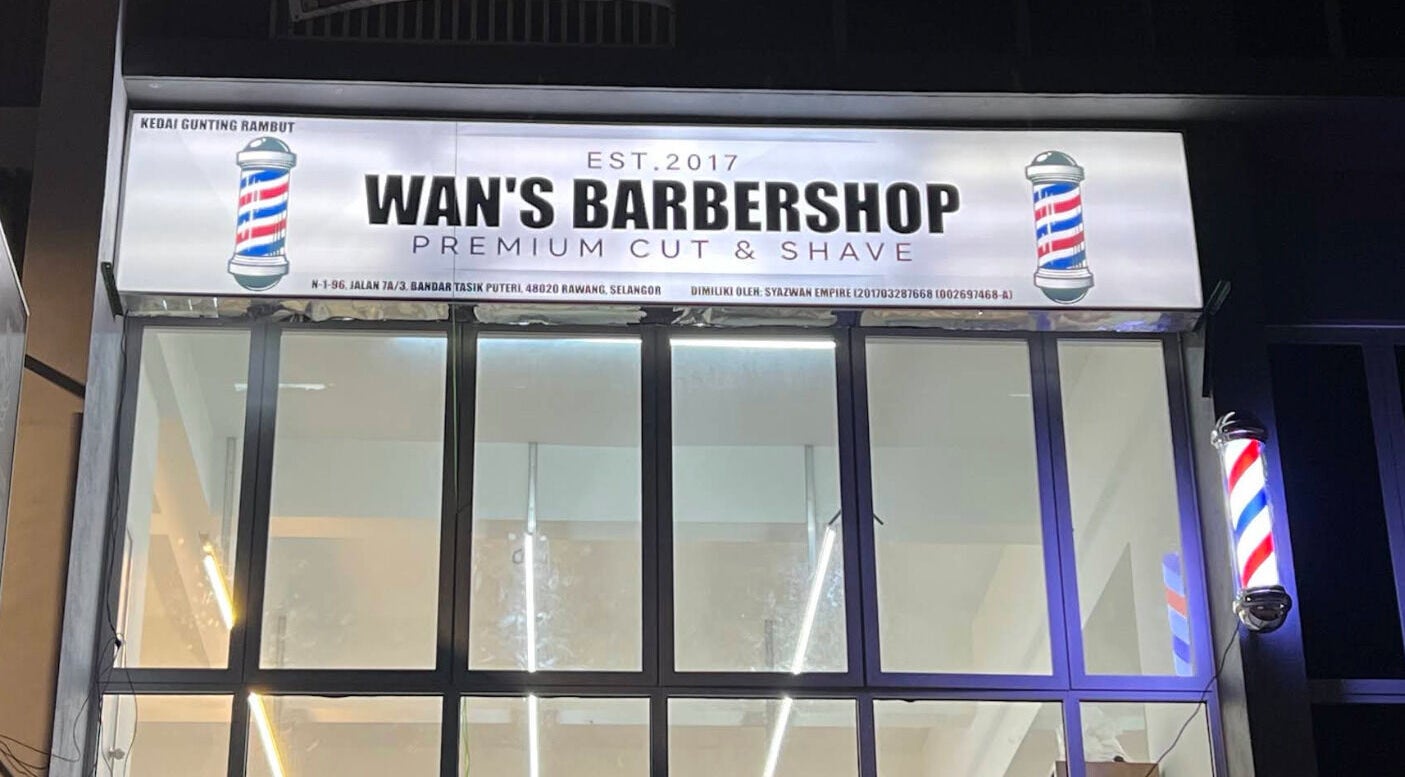 Illuminated sign of Wan’s Barbershop Tasik Puteri in Rawang, Selangor, MY showcasing premium styling services.