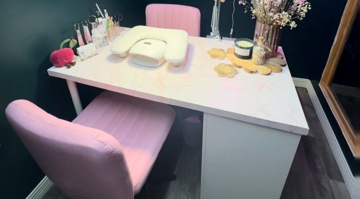 Elegant nail station at KB Nails Beauty, Purbrook, England. Features pink chairs and decor.