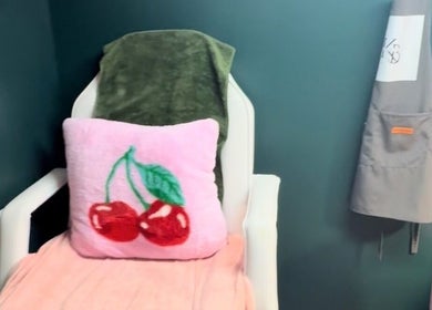 Cozy chair with pink cherry pillow at KB Nails Beauty, Purbrook, England, GB.