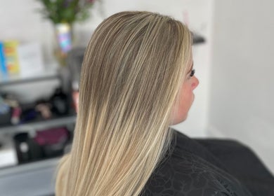 Blonde hairstyle at Hair Craft & Co, Torquay, England, GB. Sleek finish and salon ambiance.