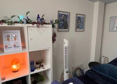 Therapy room at Natural Balance Holistic Therapy, Allerton Bywater, England, featuring decor and a reflexology chart.