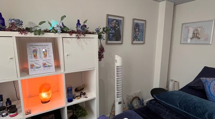 Therapy room at Natural Balance Holistic Therapy, Allerton Bywater, England, featuring decor and a reflexology chart.
