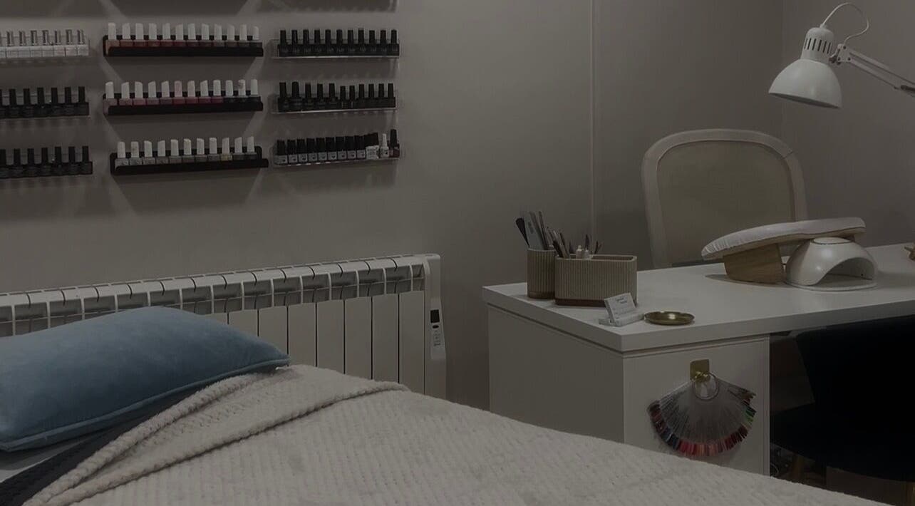 Elegant nail care station at Radiant Beauty in Clitheroe, England, GB with cozy bedding and organized polish display.