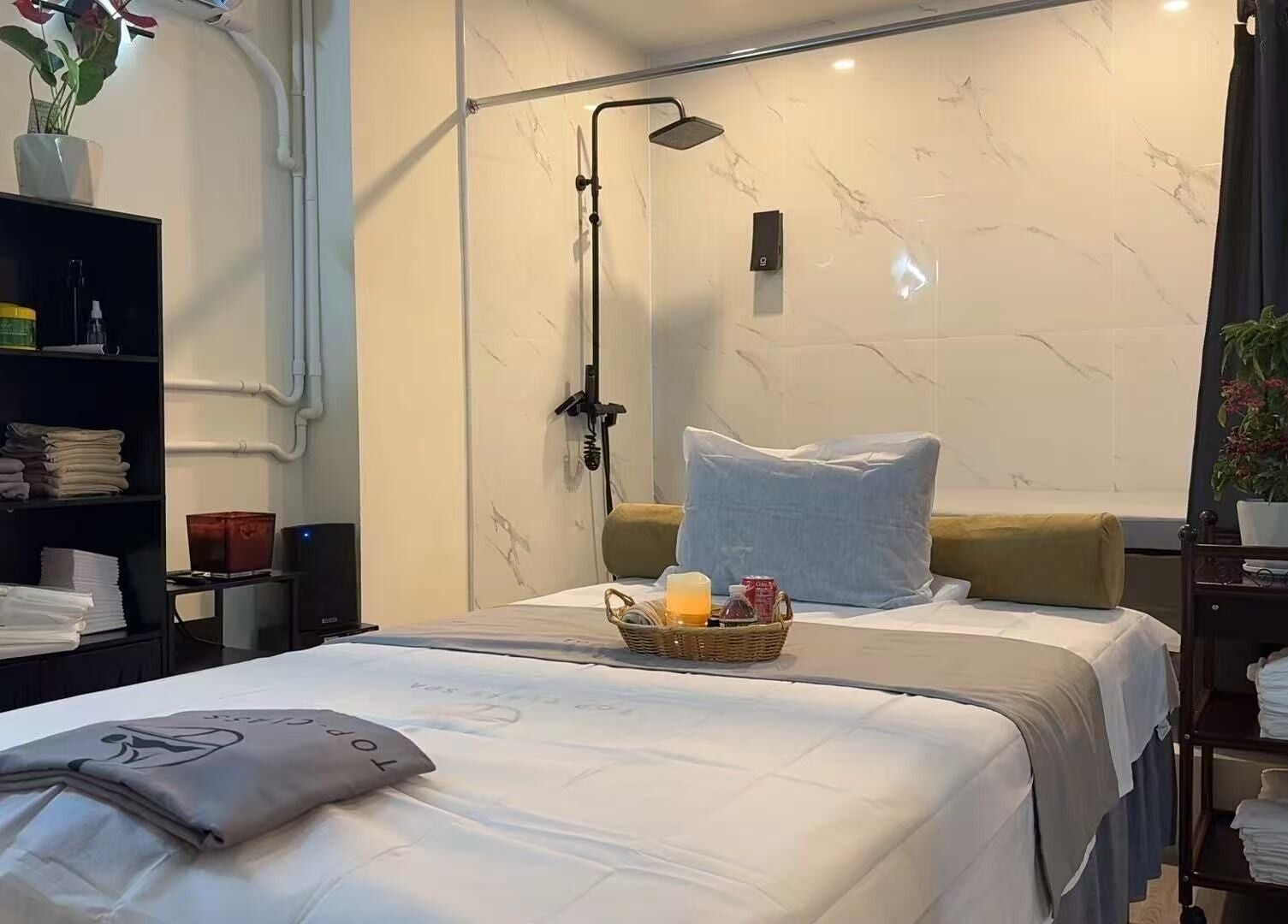 Relaxing spa room at TOP-CLASS SPA, New York, New York, US with plush bed and calming decor.