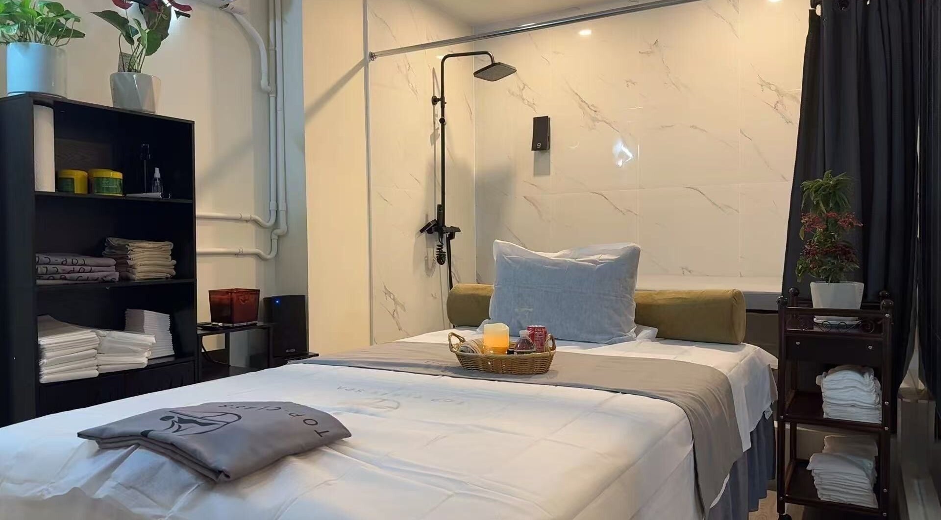 Relaxing spa room at TOP-CLASS SPA, New York, New York, US with plush bed and calming decor.