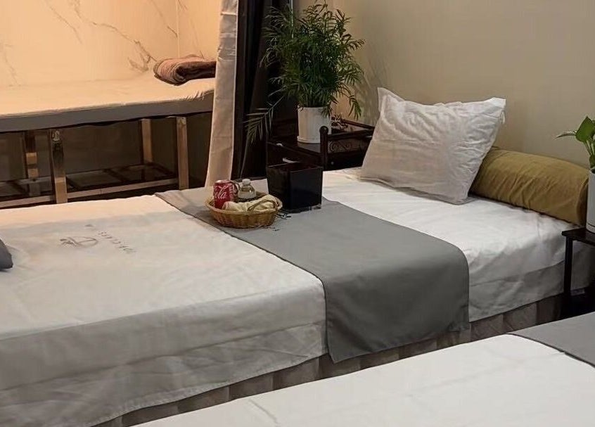 Relaxing treatment room at TOP-CLASS SPA, New York, New York, US, featuring comfortable beds and calming decor.