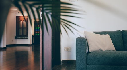 Inviting lounge at Sage Centre, Subang Jaya, Selangor, MY, featuring a cozy gray sofa and elegant decor.