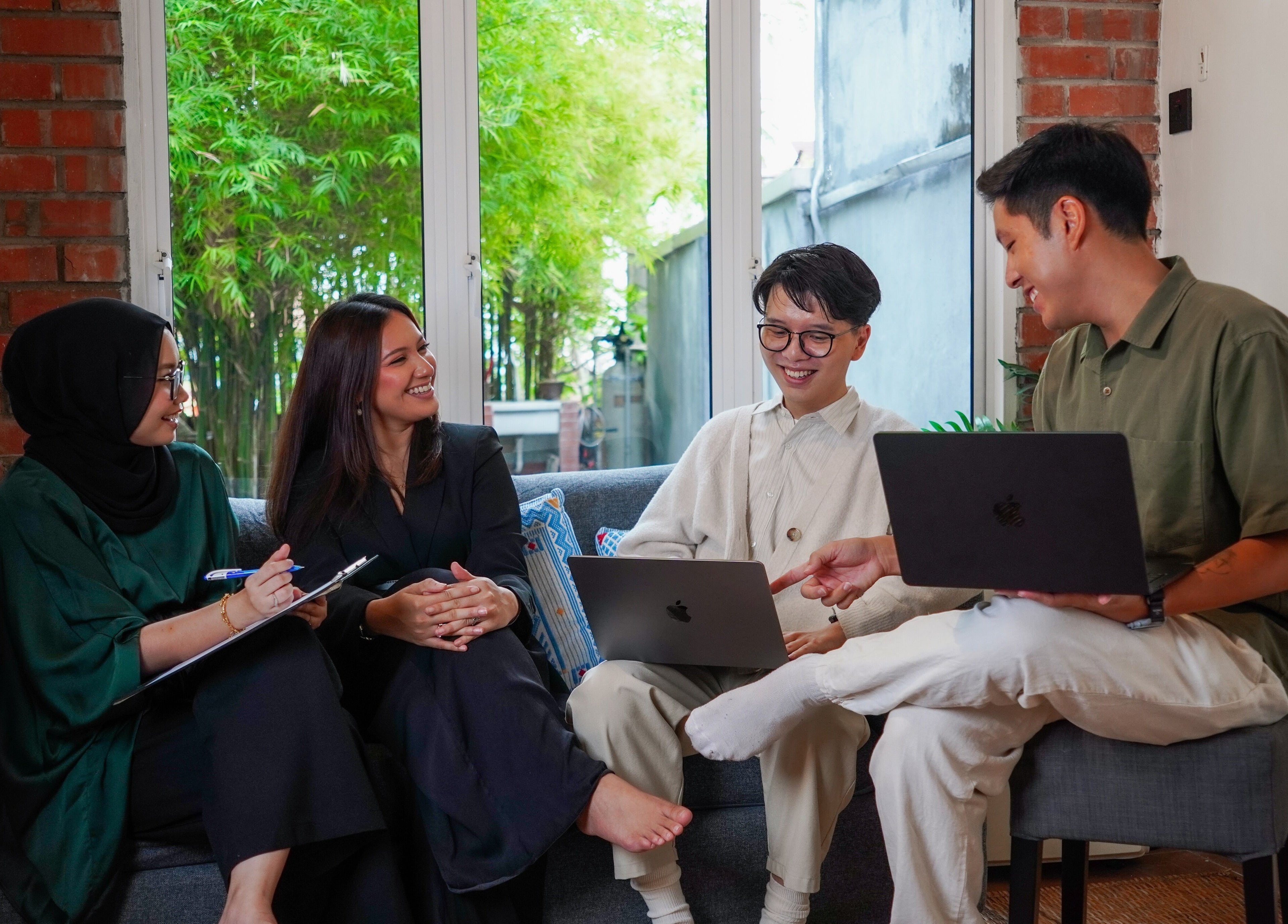 Visitors engaging in conversation at Sage Centre, Subang Jaya, Selangor, MY, in a modern and cozy lounge setting.