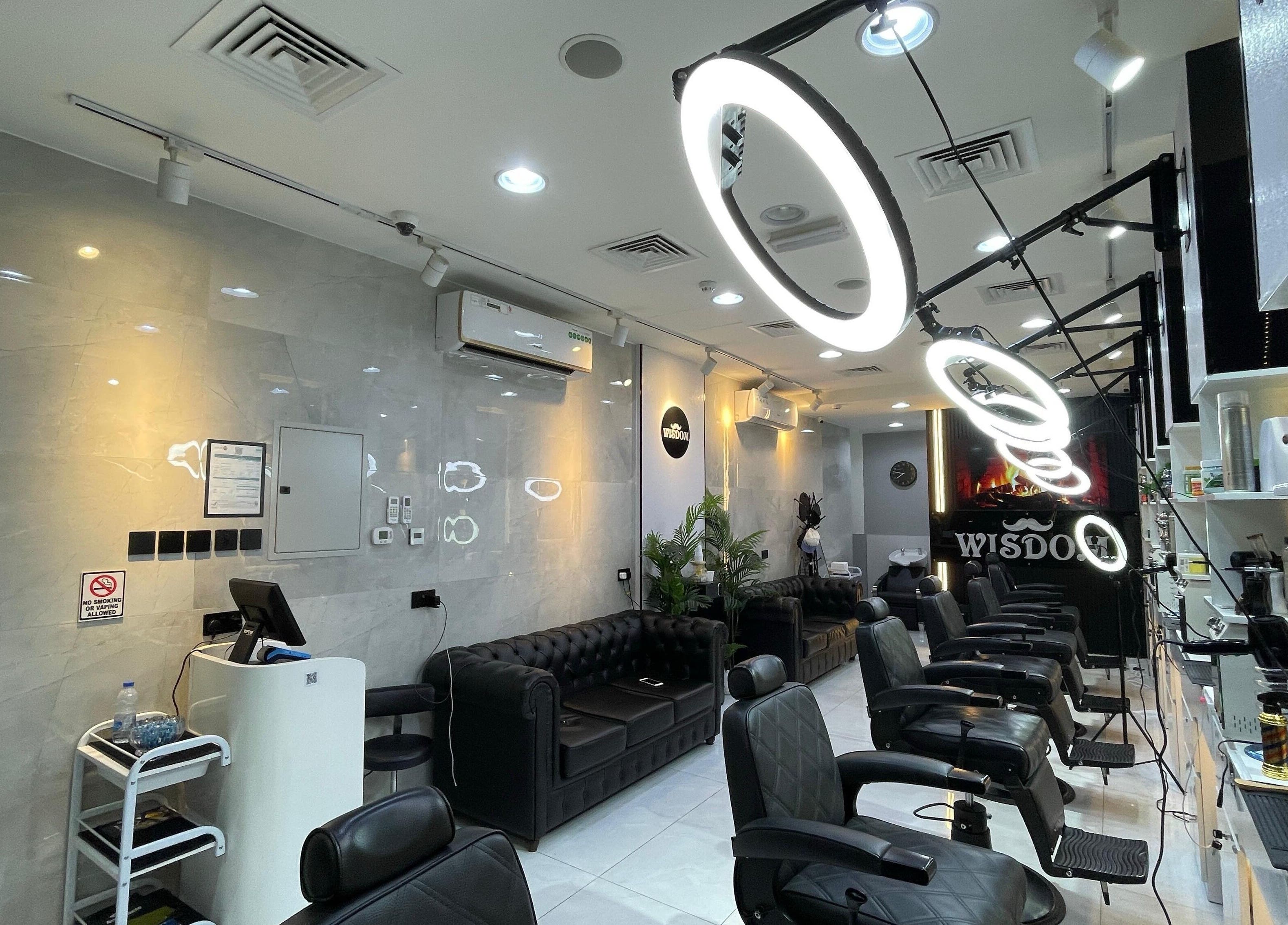 Chic interior of Wisdom Gents Saloon in Dubai, AE with elegant seating and stylish decor.