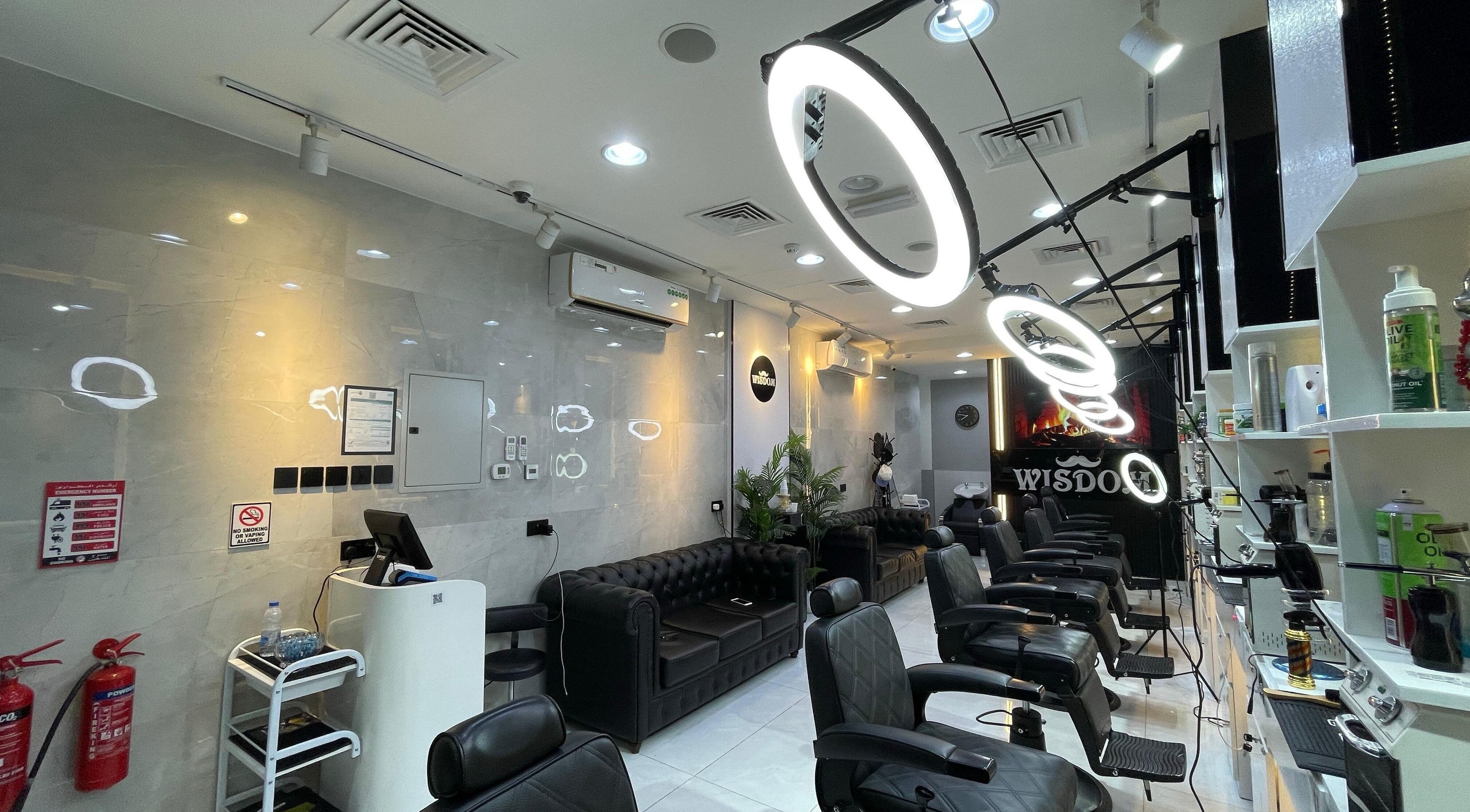 Chic interior of Wisdom Gents Saloon in Dubai, AE with elegant seating and stylish decor.