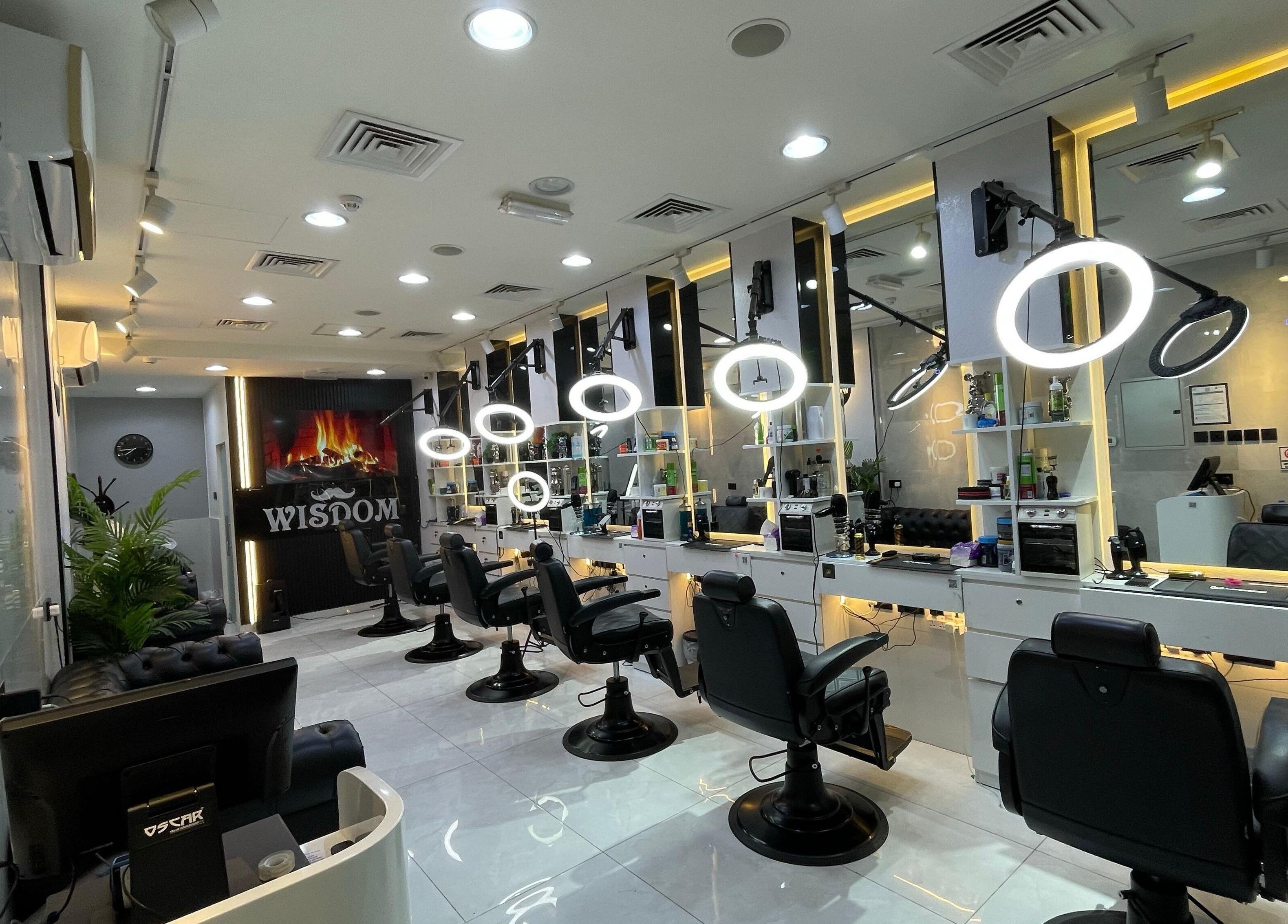 Interior of Wisdom Gents Saloon in Dubai, AE with modern barber stations and elegant lighting.