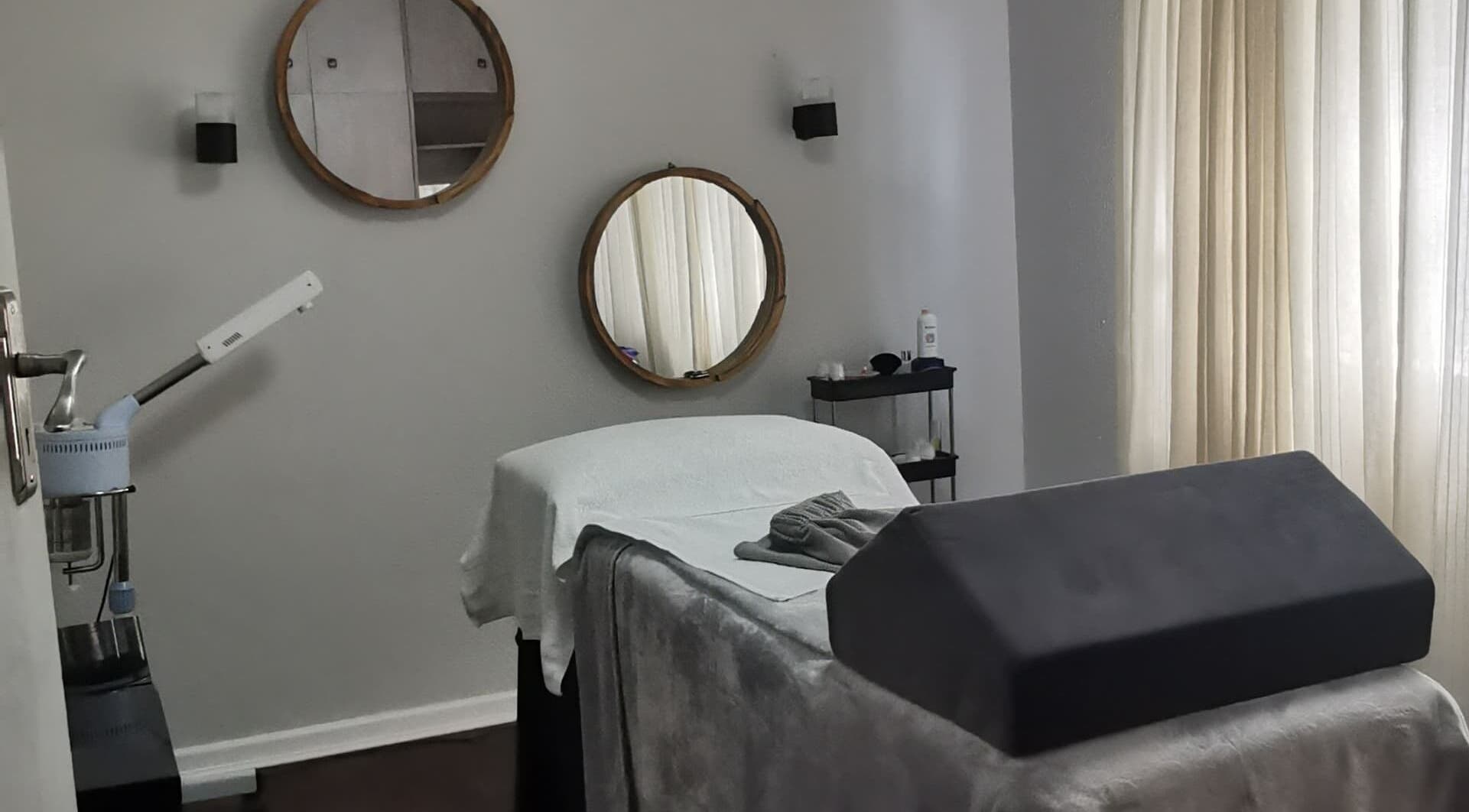 Treatment room at Paffetto Skin Aesthetics in Cape Town, Western Cape, ZA featuring cozy bed and elegant decor.
