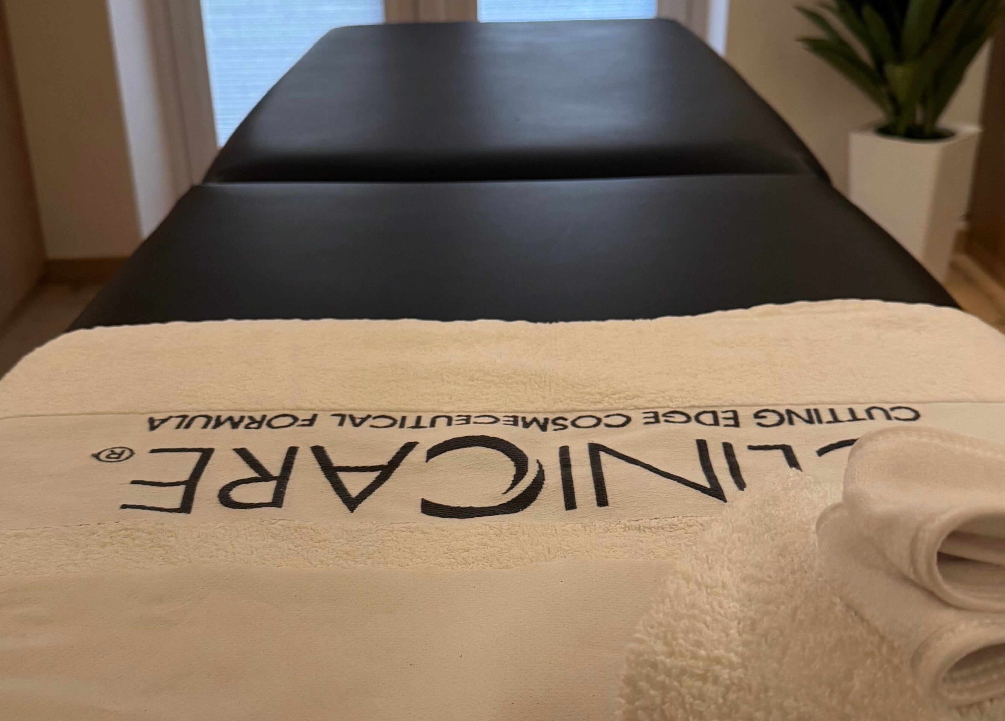 Massage table at Definir in Galston, Scotland, GB, with a neatly folded towel, creating a serene spa atmosphere.