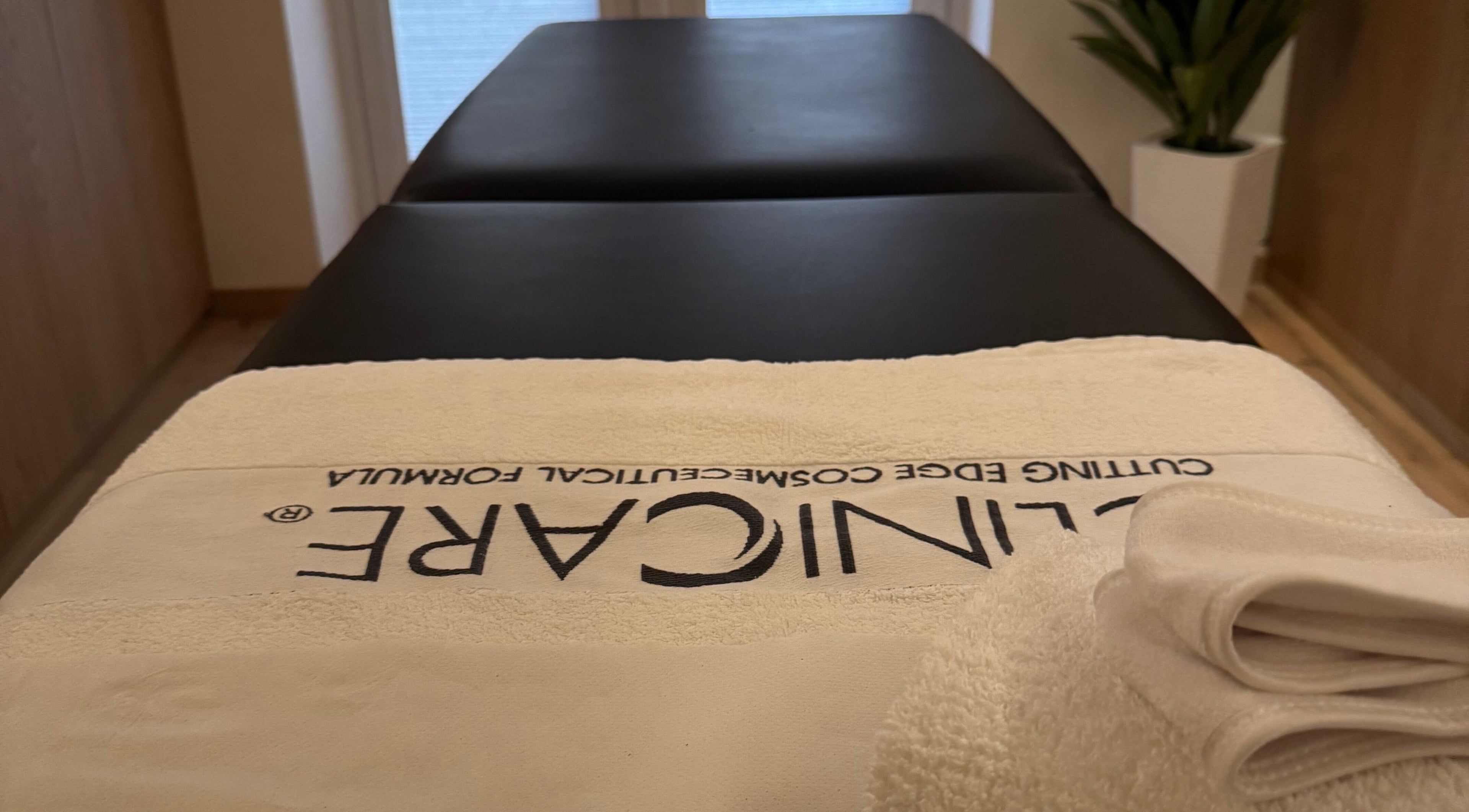 Massage table at Definir in Galston, Scotland, GB, with a neatly folded towel, creating a serene spa atmosphere.
