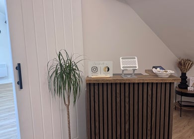 Reception desk at Kate's Studio in Coalville, England, GB showcasing a modern interior with natural decor.