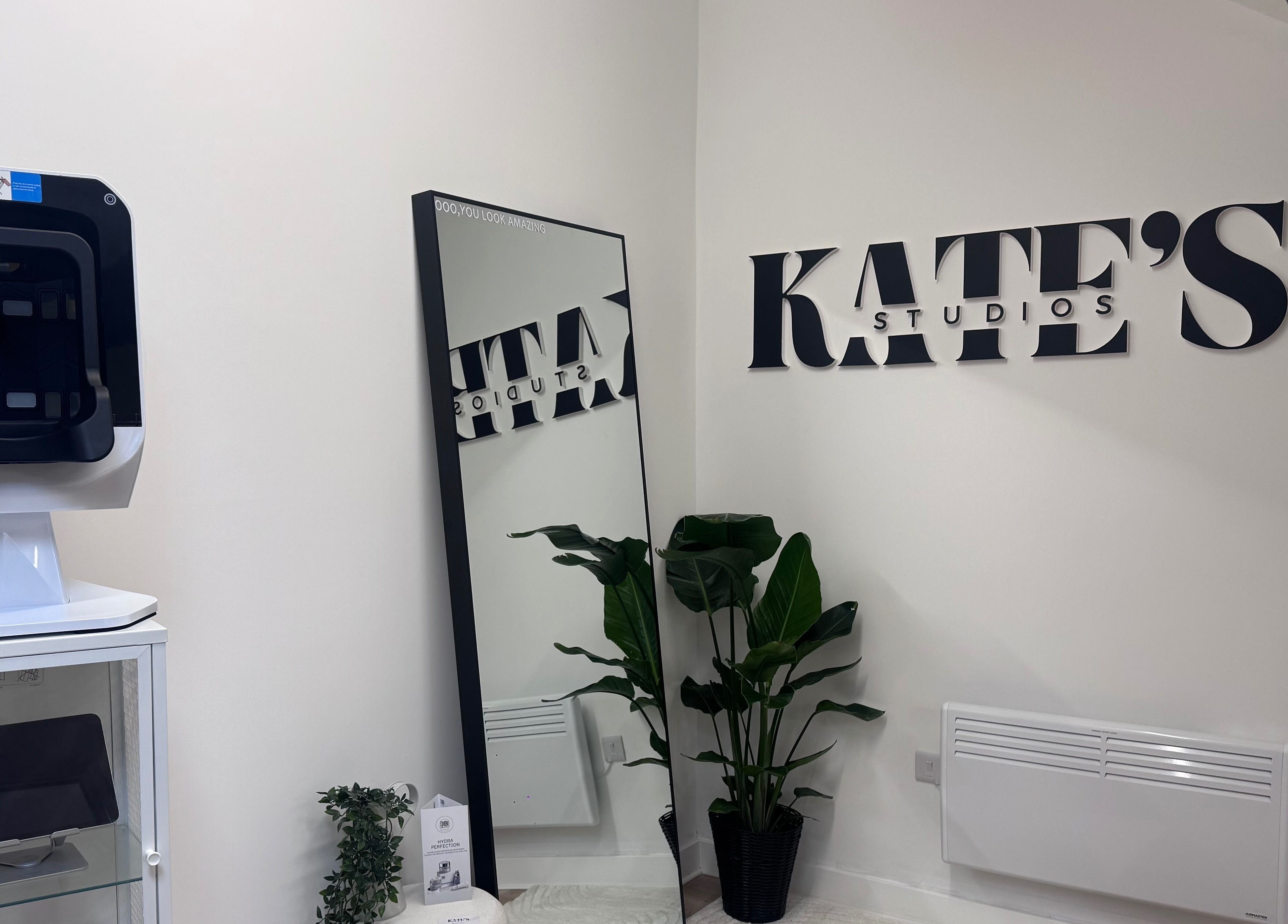 Sleek interior of Kate's Studio in Coalville, England, featuring a mirror and stylish decor.