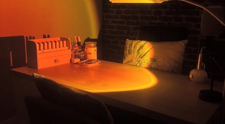 Warmly lit nail station at Ameerah Grace Nails, Lytham Saint Annes, England, GB, featuring organized polish display.