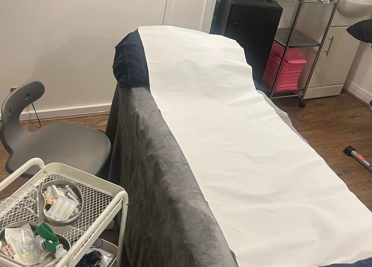 Treatment room at AMORE Aesthetics, London, England, GB, showcasing a well-prepared beauty bed.