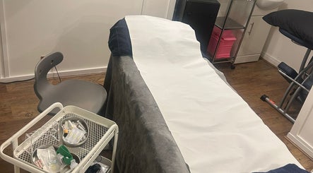 Treatment room at AMORE Aesthetics, London, England, GB, showcasing a well-prepared beauty bed.
