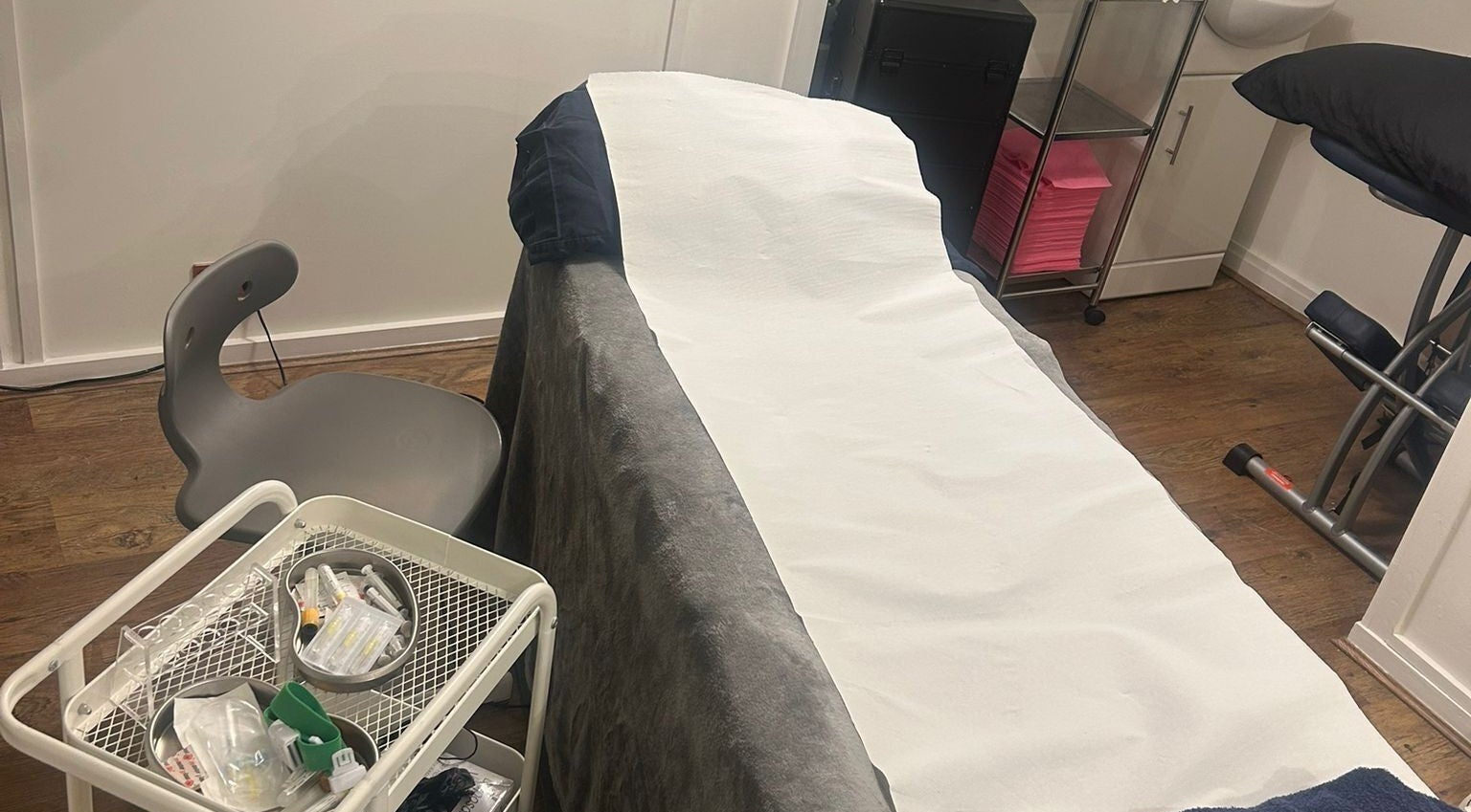 Treatment room at AMORE Aesthetics, London, England, GB, showcasing a well-prepared beauty bed.