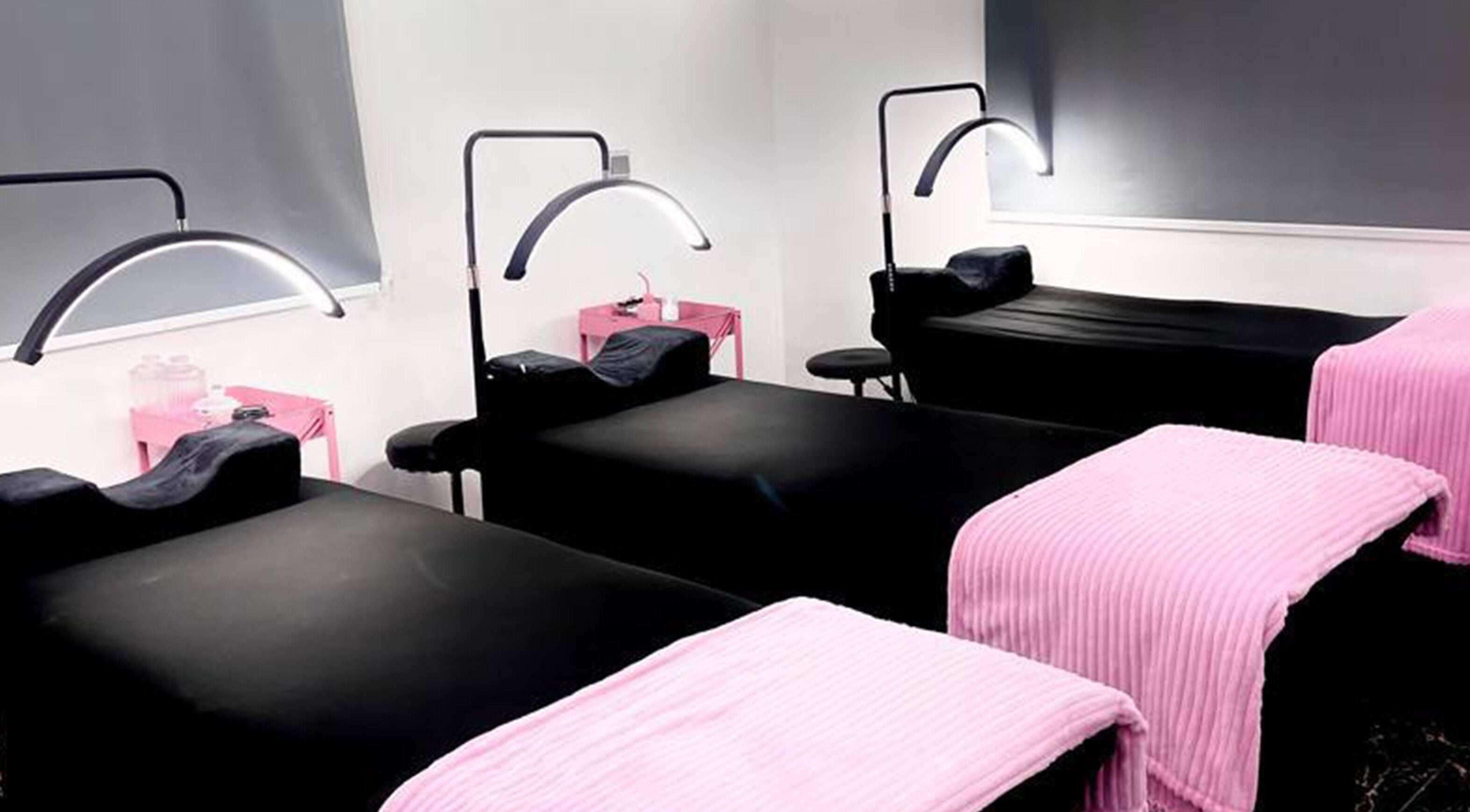 Relaxing massage beds at Net Beauty Africa in Lagos, Lagos, NG, with soothing pink and black decor.