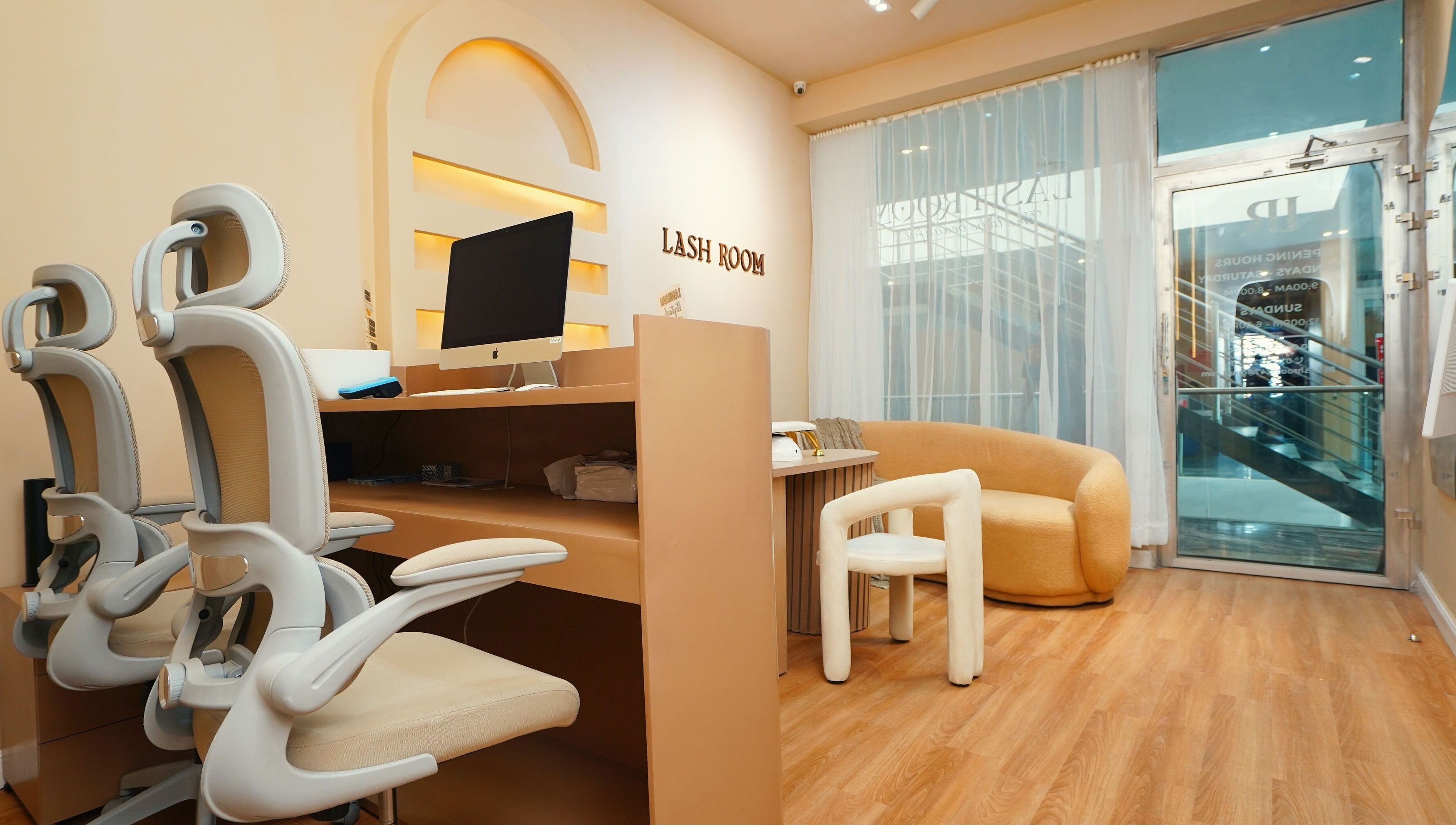Modern interior of Lash Room in Lagos, Lagos, NG with stylish chairs and a computer desk.