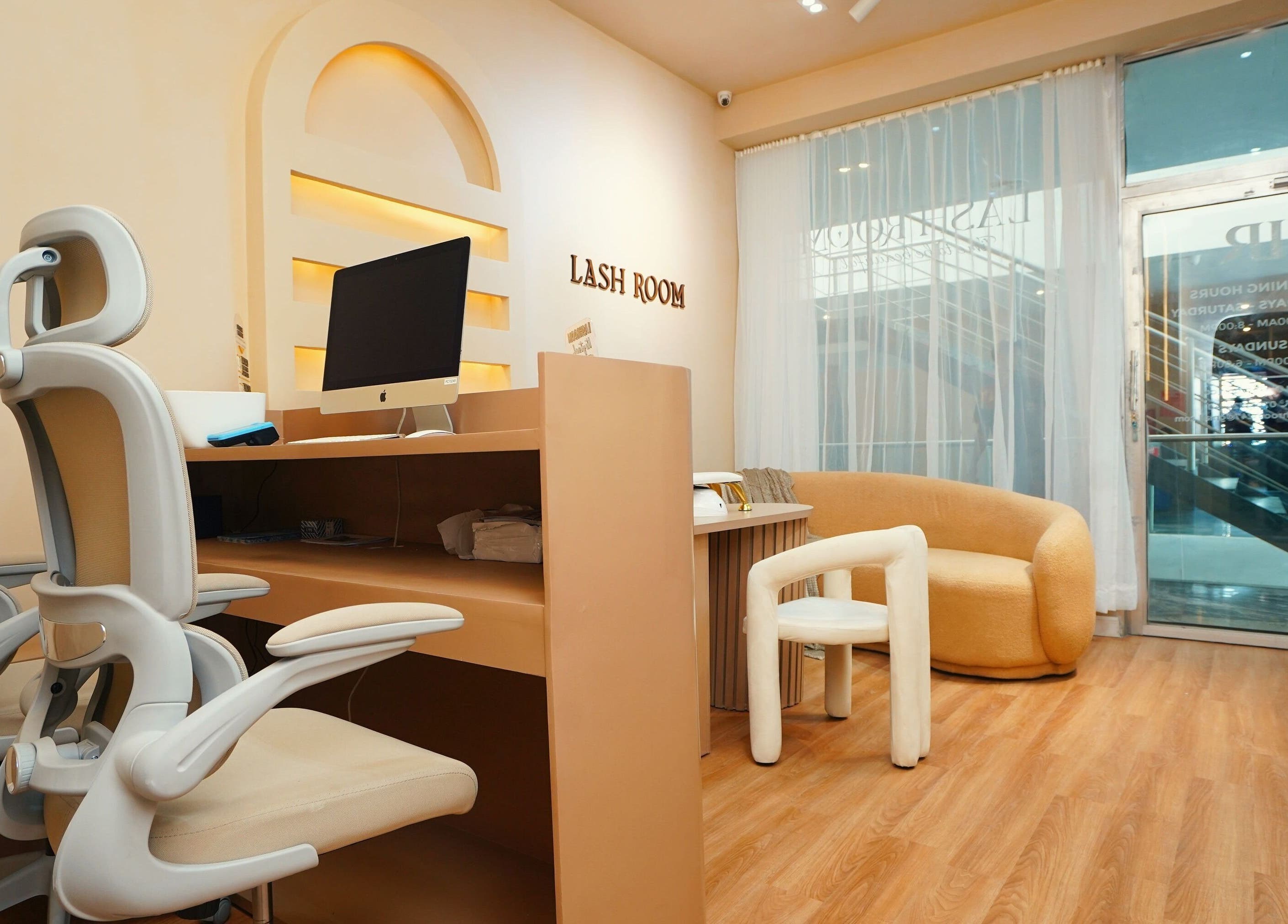 Modern interior of Lash Room in Lagos, Lagos, NG with stylish chairs and a computer desk.