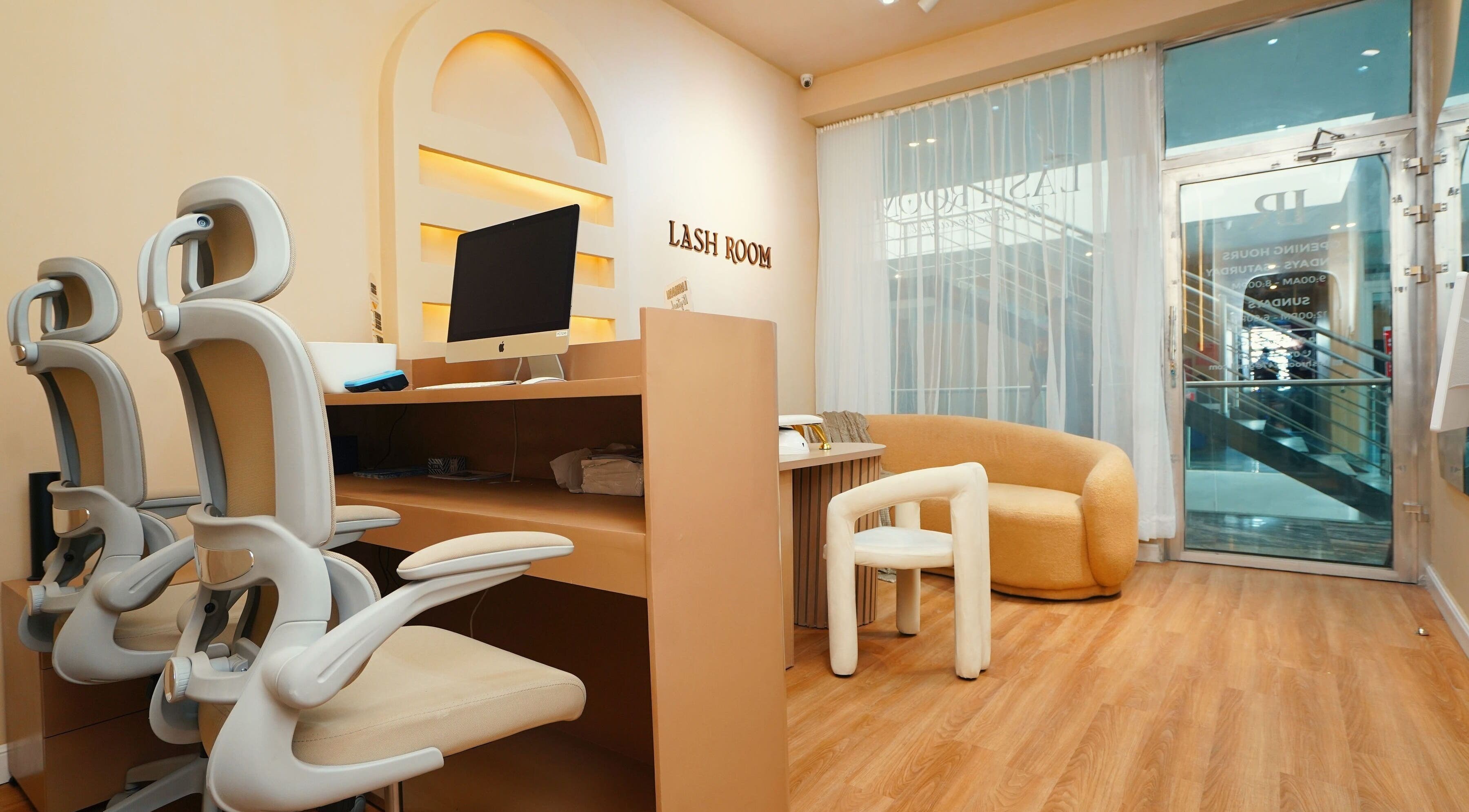 Modern interior of Lash Room in Lagos, Lagos, NG with stylish chairs and a computer desk.