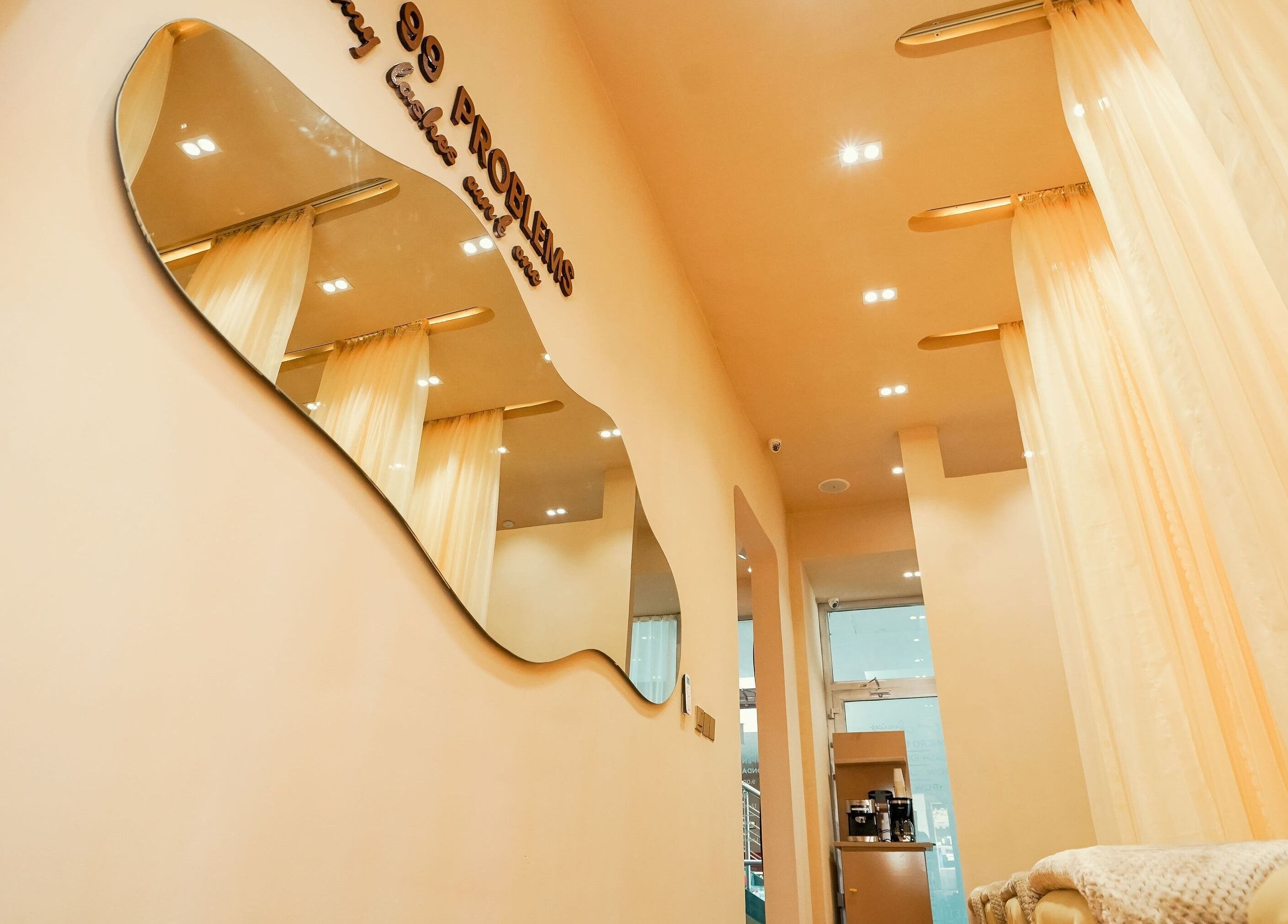 Modern interior of Lash Room in Lagos, Lagos, NG, featuring elegant mirrors and cozy lighting.