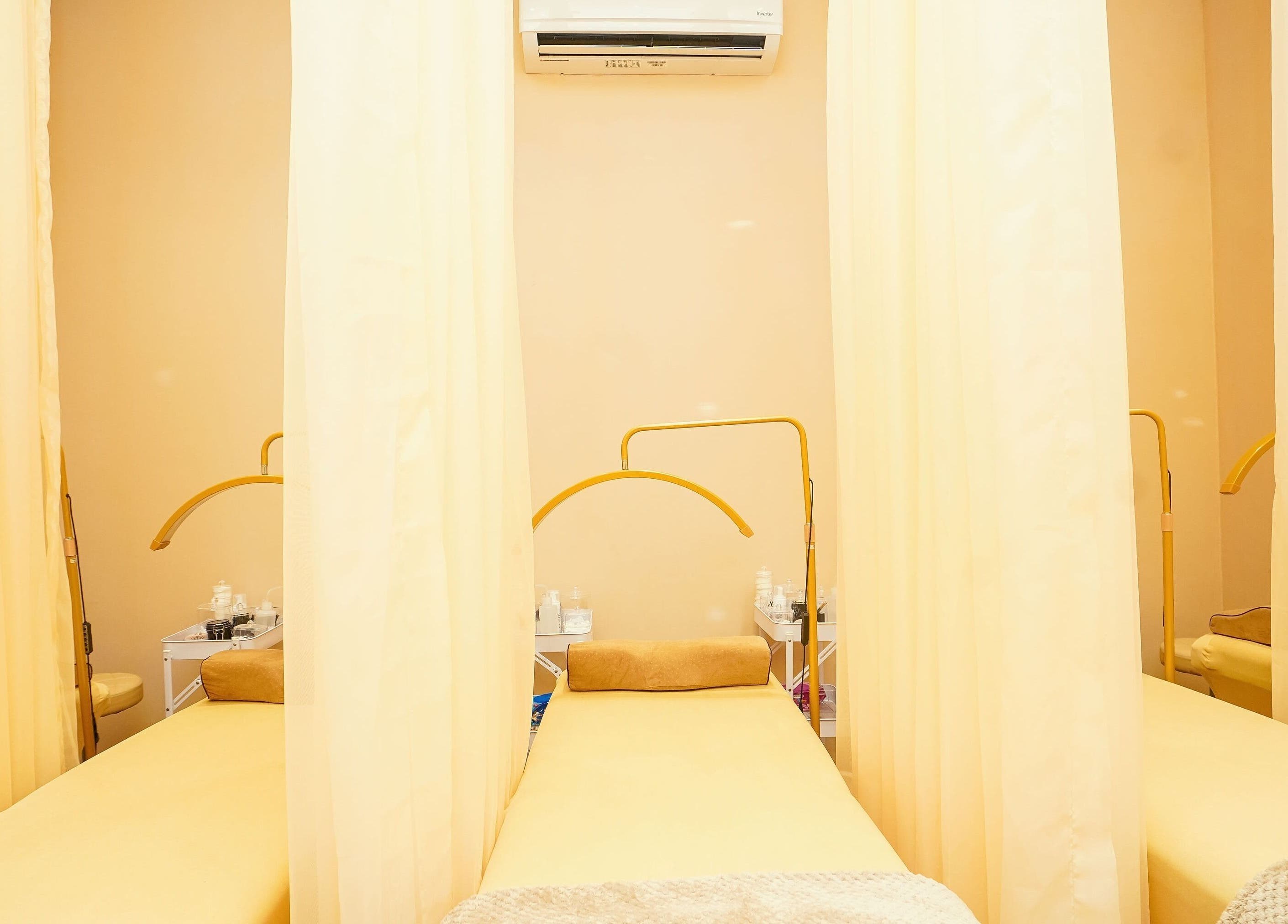 Elegant treatment room at Lash Room, Lagos, Lagos, NG, featuring soft lighting and a comfortable bed.