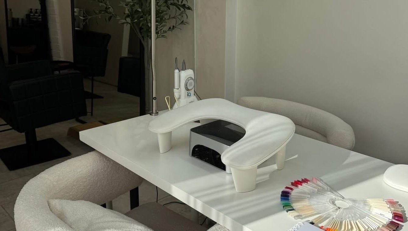 Modern nail station at By Evangeline in Plymouth, England, GB, featuring sleek tools and colorful polish samples.