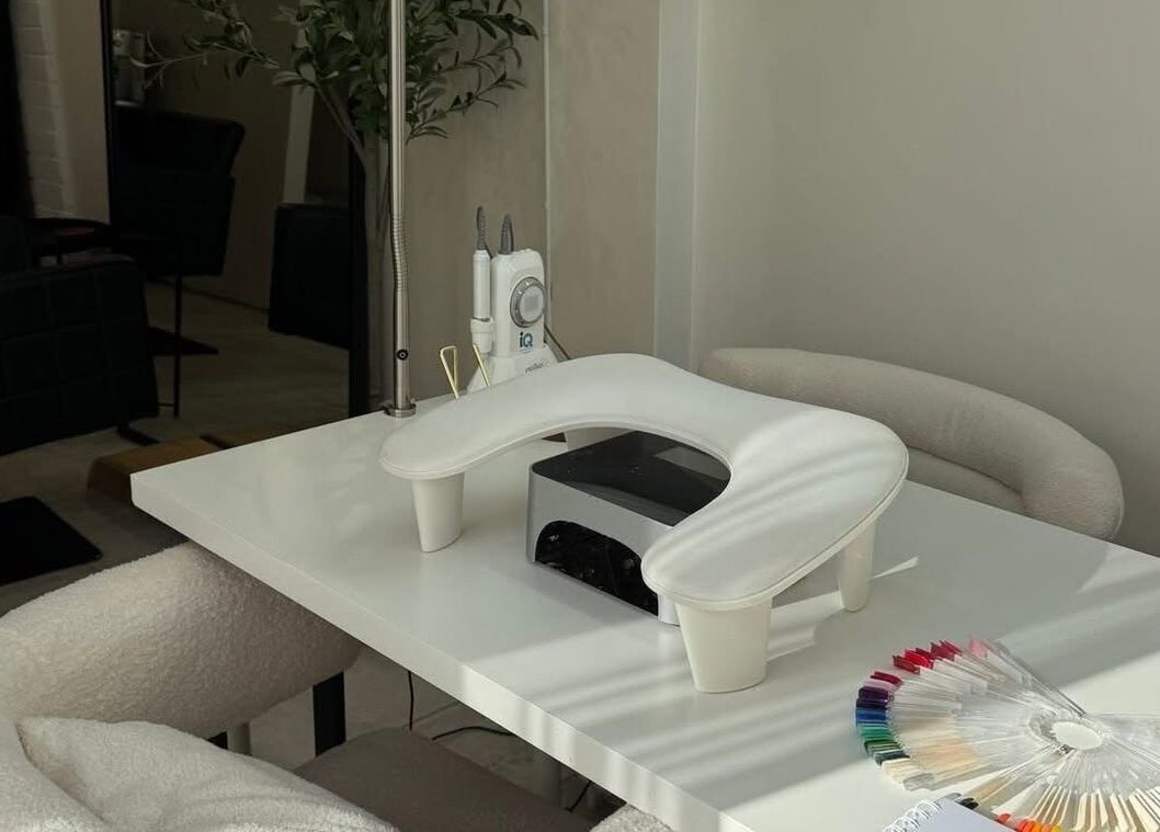 Modern nail station at By Evangeline in Plymouth, England, GB, featuring sleek tools and colorful polish samples.