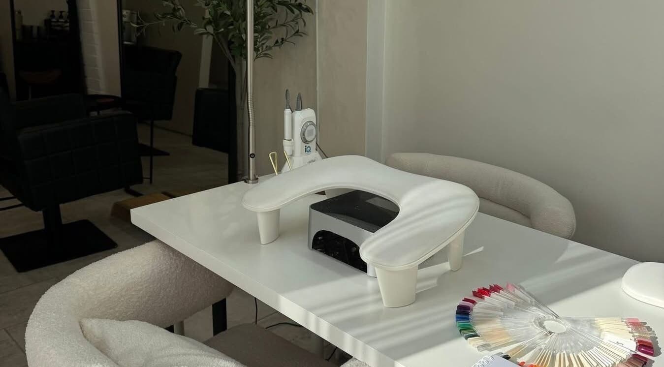 Modern nail station at By Evangeline in Plymouth, England, GB, featuring sleek tools and colorful polish samples.