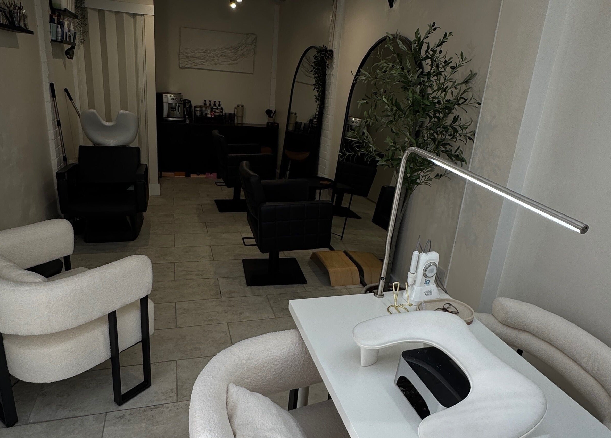 Cozy interior of By Evangeline, a beauty salon in Plymouth, England, GB with modern chairs and manicure table.