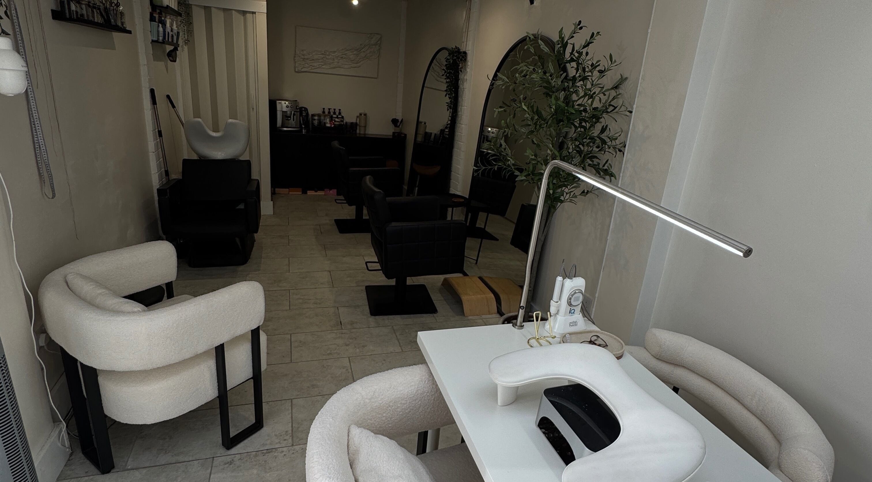 Cozy interior of By Evangeline, a beauty salon in Plymouth, England, GB with modern chairs and manicure table.