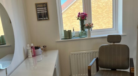 Bright treatment room at Neve Amelia Beauty, Daventry, England showcasing a chair and skincare products by the window.