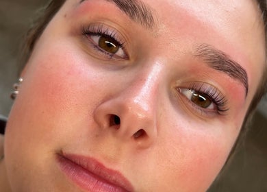 Close-up of a woman's glowing skin and perfect brows at Neve Amelia Beauty, Daventry, England, GB.