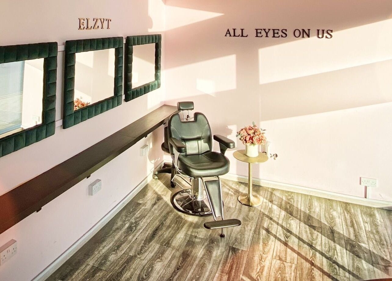 Elegant styling chair at Elzyt Brows by Patricija, Drogheda, County Louth, IE with mirrors and floral decor.